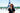 A black woman stands smiles at the camera with the Eiffel Tower behind her