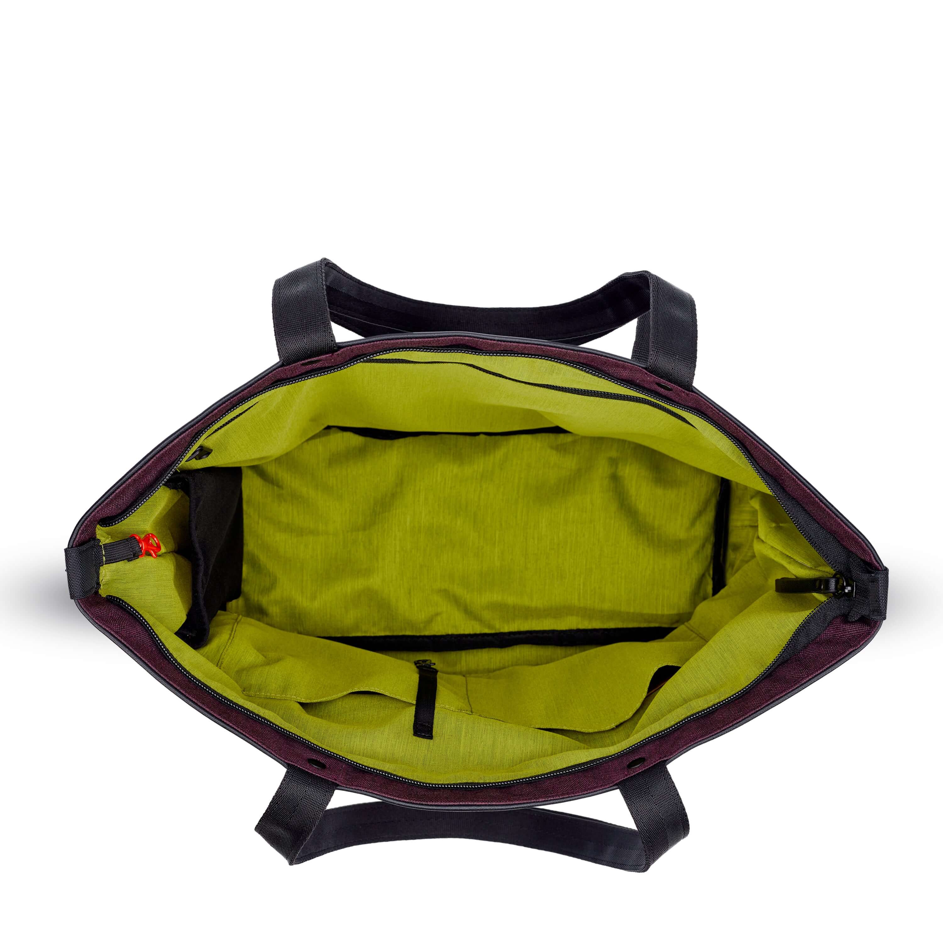 Top view of Sherpani's Anti-Theft tote the Cali AT in Merlot. The main zipper compartment is open to reveal a lime green interior, an internal water bottle holder and a red carabiner that acts as the zipper lock. 