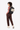 A model carries Sherpani three-in-one bag, the Camden in Con Leche, as a backpack. #color_con-leche