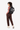 A model carries Sherpani three-in-one bag, the Camden in Magnolia, as a backpack. #color_magnolia