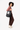 A model carries Sherpani three-in-one bag, the Camden in Magnolia, as a tote. #color_magnolia