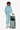 Model with the Sherpani Eclipse AT in Basil resting on top of a Sherpani Meridian suitcase #color_basil