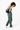 Model bending slightly forward and smiling, wearing the Sherpani sling bag, the Esprit in Magnolia #color_magnolia