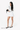 A model holds the Sherpani travel accessory, the Jolie in Raven at her waistband. #color_raven