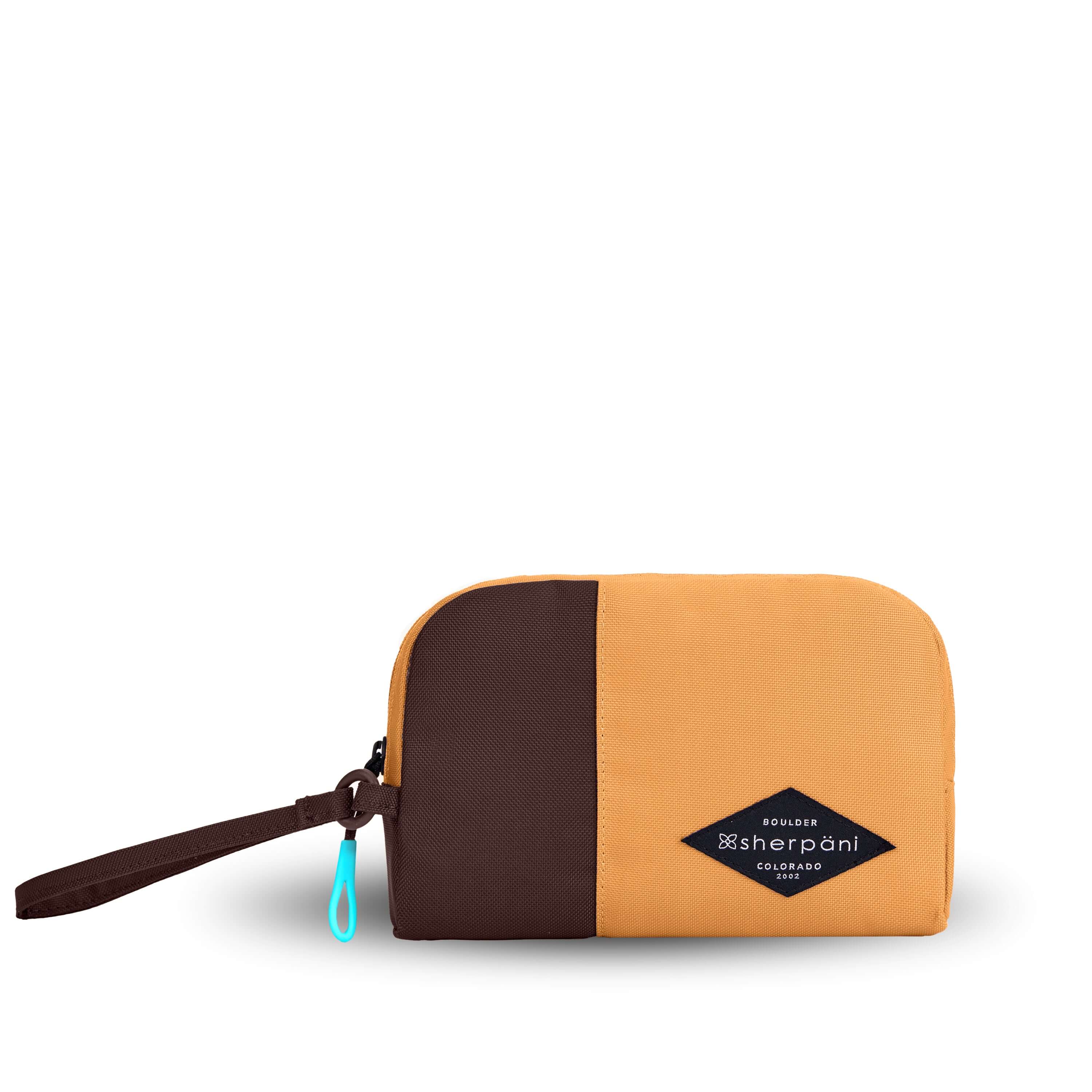 Flat front view of Sherpani travel accessory, the Jolie in Sundial, in medium size. The pouch is two-toned in burnt yellow and brown. It features a brown wristlet strap and an easy-pull zipper accented in aqua. 