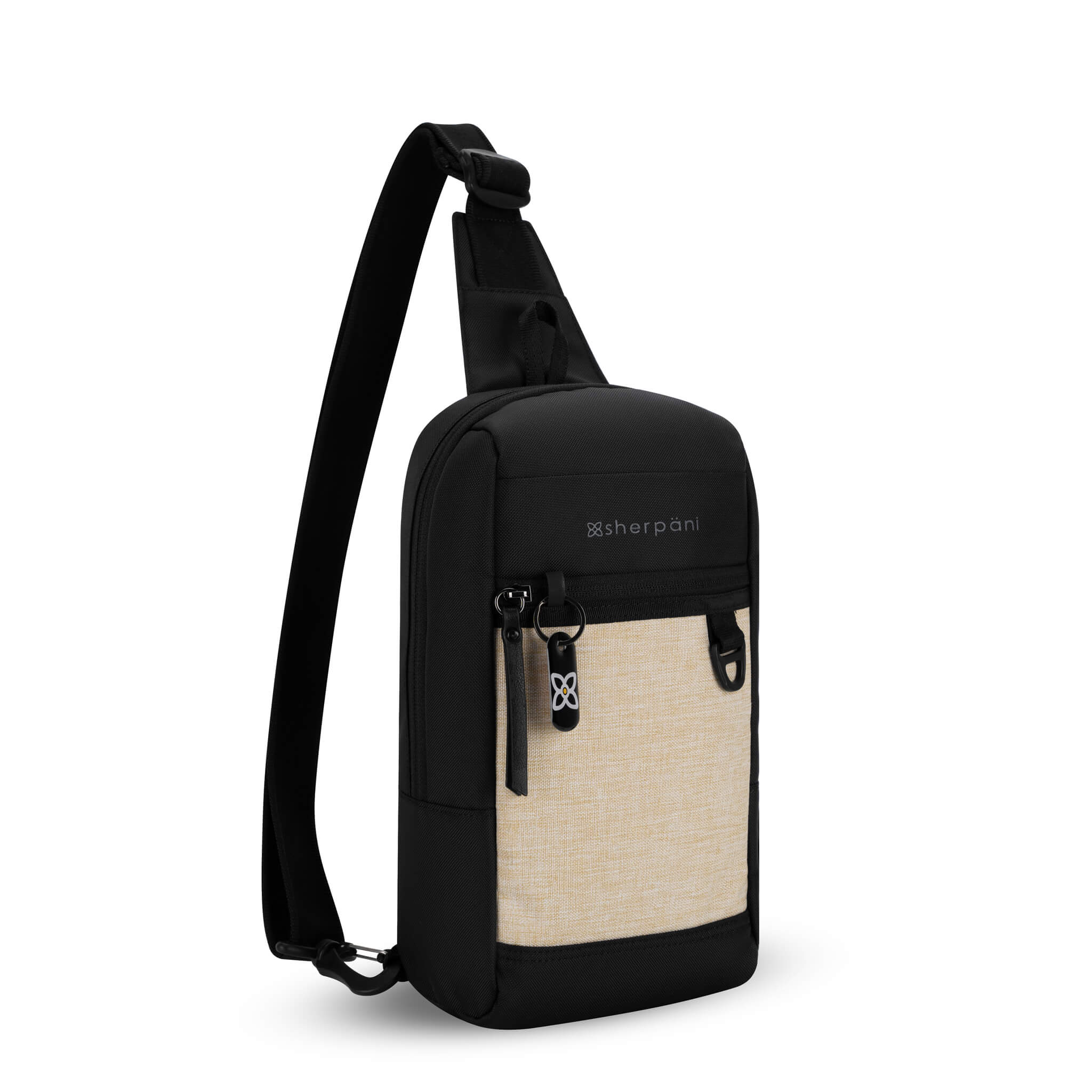 Angled front view of Sherpani mini sling backpack, the Metro in Straw. This Anti-Theft sling includes security features for safe travels and an adjustable crossbody strap that can convert the Metro to a left-handed design. 