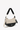 Model holding the Sherpani crossbody, the Mina in Con Leche. #color_con-leche