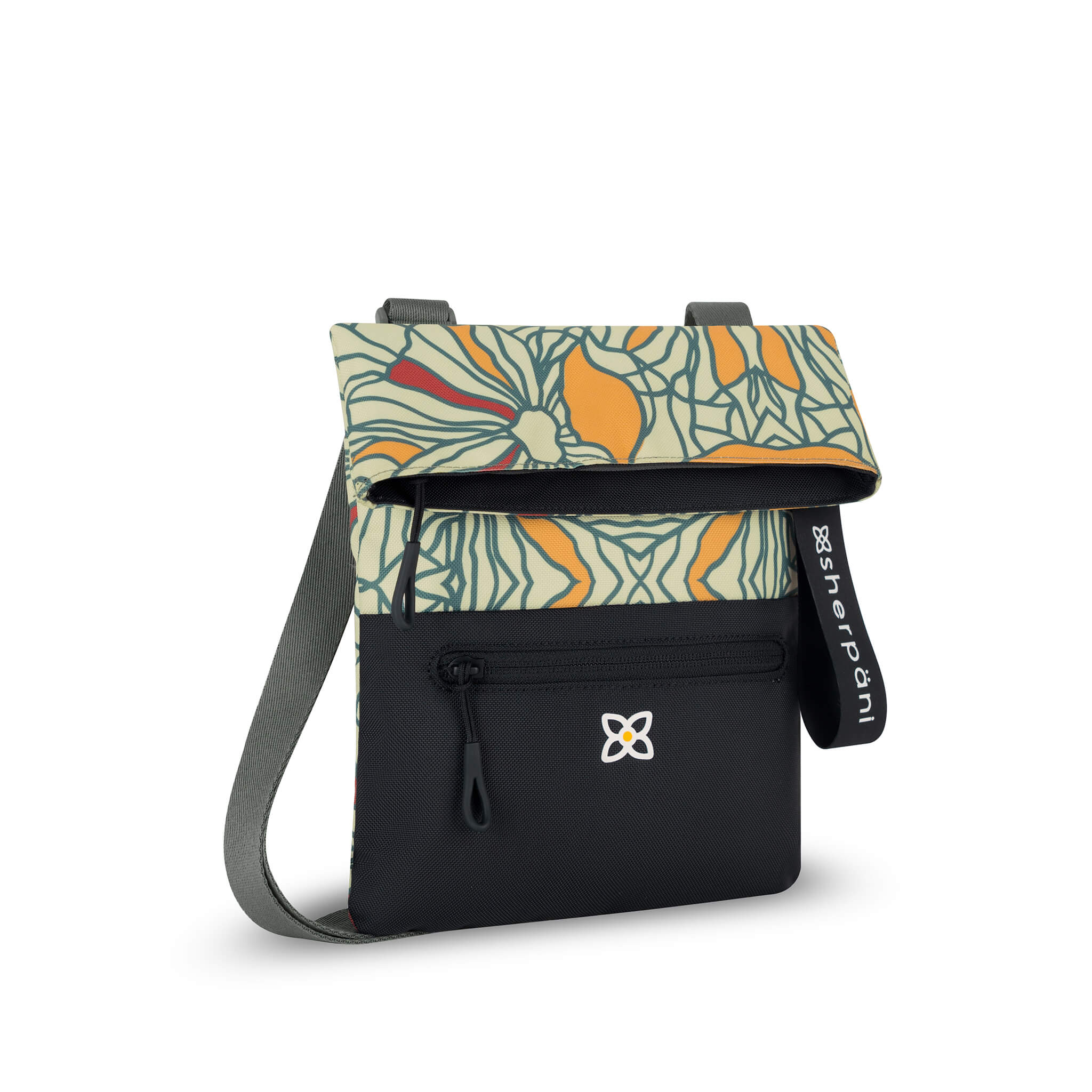 Angled front view of Sherpani fold over crossbody bag, the Pica in Fiori. Pica features include an adjustable crossbody strap, outside zipper pocket, back flap pocket, inside zipper pocket and slip pocket, detachable keychain and RFID protection. The Fiori colorway is two-toned in black and a floral pattern with red accents. 