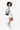 Model turned slightly to the side, wearing the Sherpani crossbody, the Sadie in Magnolia. #color_magnolia