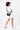 Model smiling over her right shouder, wearing the Sherpani crossbody, the Sadie in St. Lucia. #color_st-lucia
