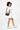 Model turned slightly to the side, wearing the Sherpani crossbody, the Sadie in Ventura '73. #color_ventura-73