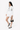 Model hold Sherpani purse, the Skye in Con Leche. #color_con-leche