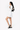 Model carries Sherpani purse, the Skye in Con Leche, as a shoulder bag. #color_con-leche