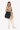Model wearing the Sherpani Soleil AT in Carbon, crossbody with the strap over her left shoulder. #color_carbon-metal