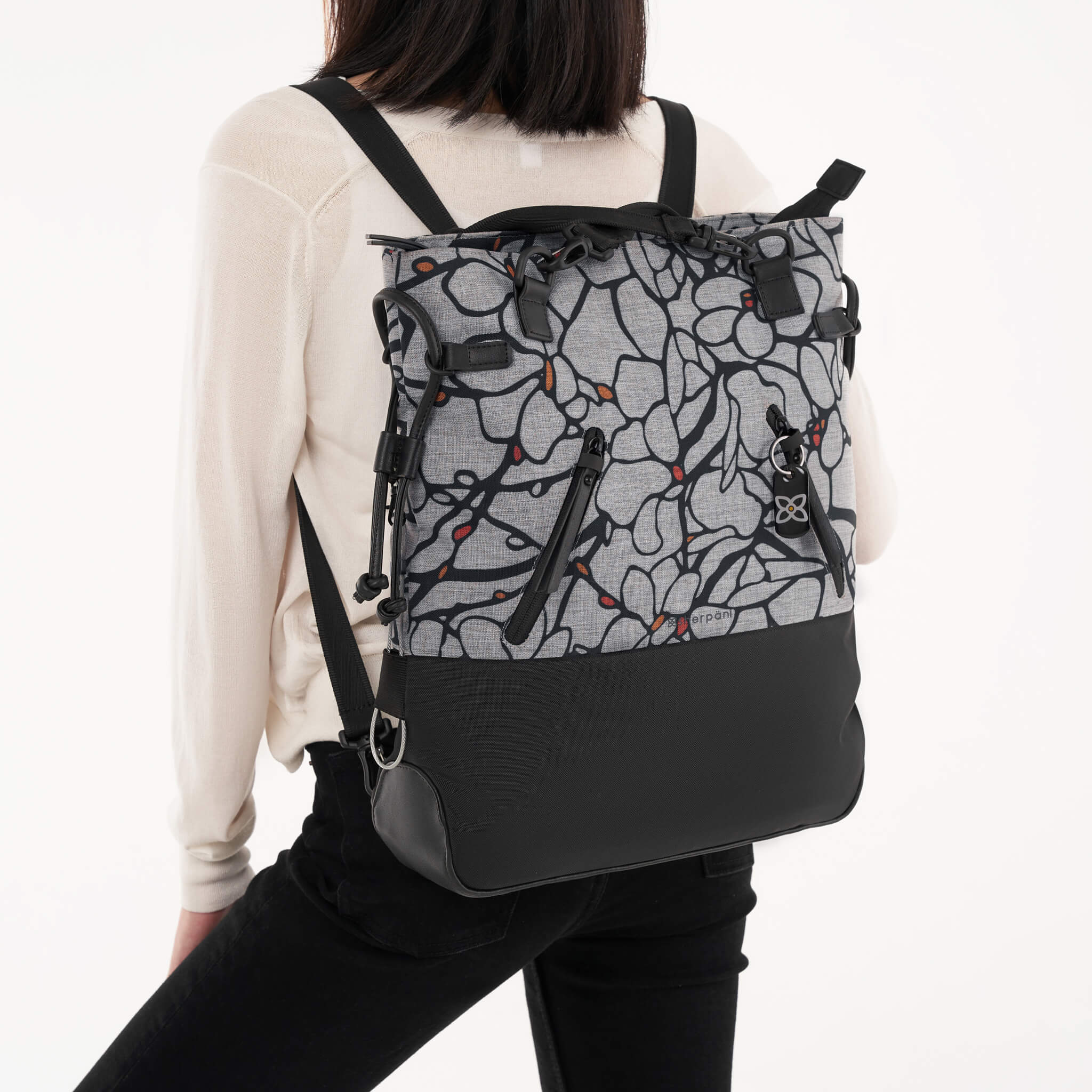 Model wearing Sherpani backpack the Tempest, a convertible tote-to-backpack design. 