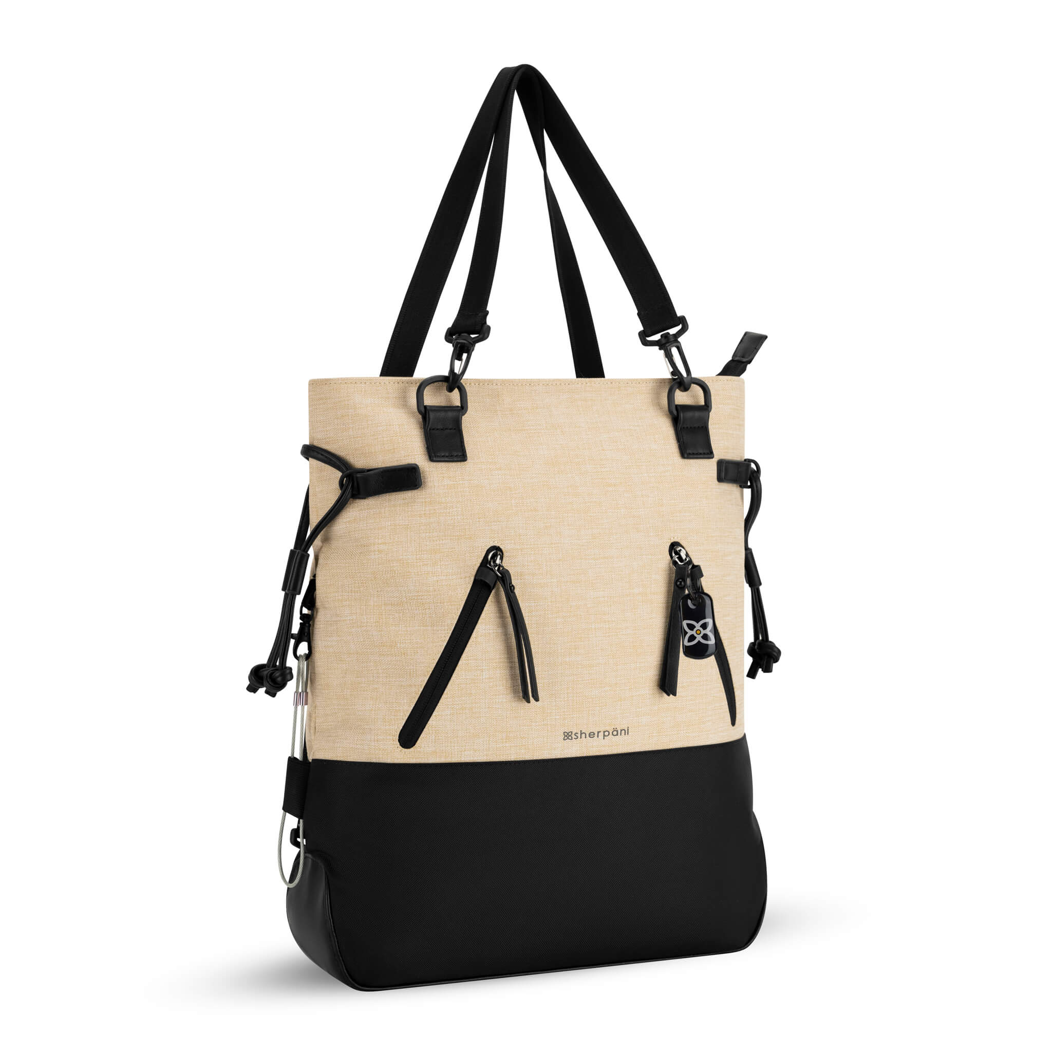 Angled front view of the Sherpani Anti-Theft tote backpack, the Tempest in Straw. The convertible bag includes RFID protection, locking zipper pockets, adjustable straps, and a trolley sleeve. #color_straw