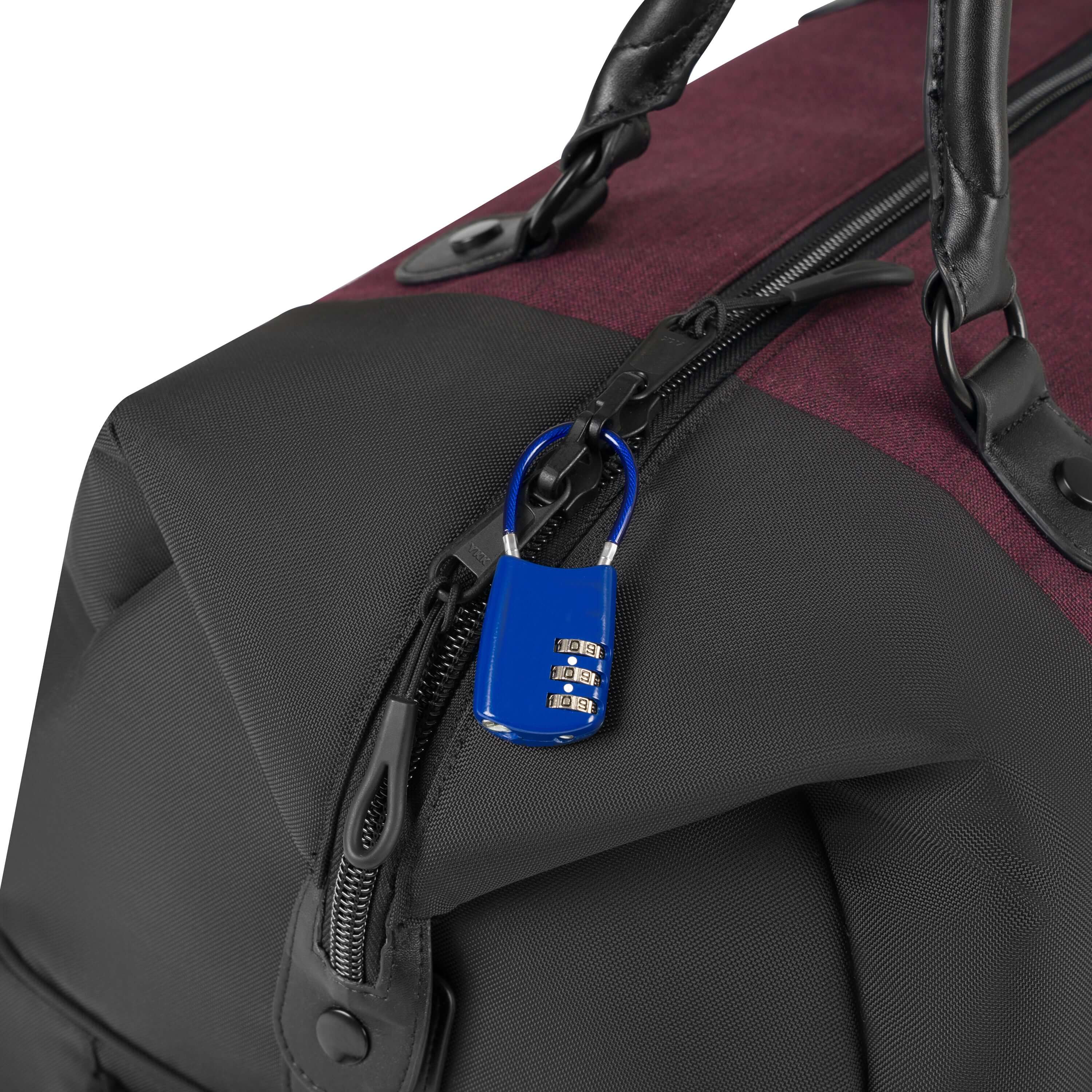 Close up view of a lock securing together the two zippers that create the main compartment of Sherpani's Anti-Theft rolling duffle the Trip in Merlot. 