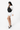 Model carries Sherpani two-way sling bag, the Wayfarer in Raven, as a sling, across the front of her chest. #color_raven