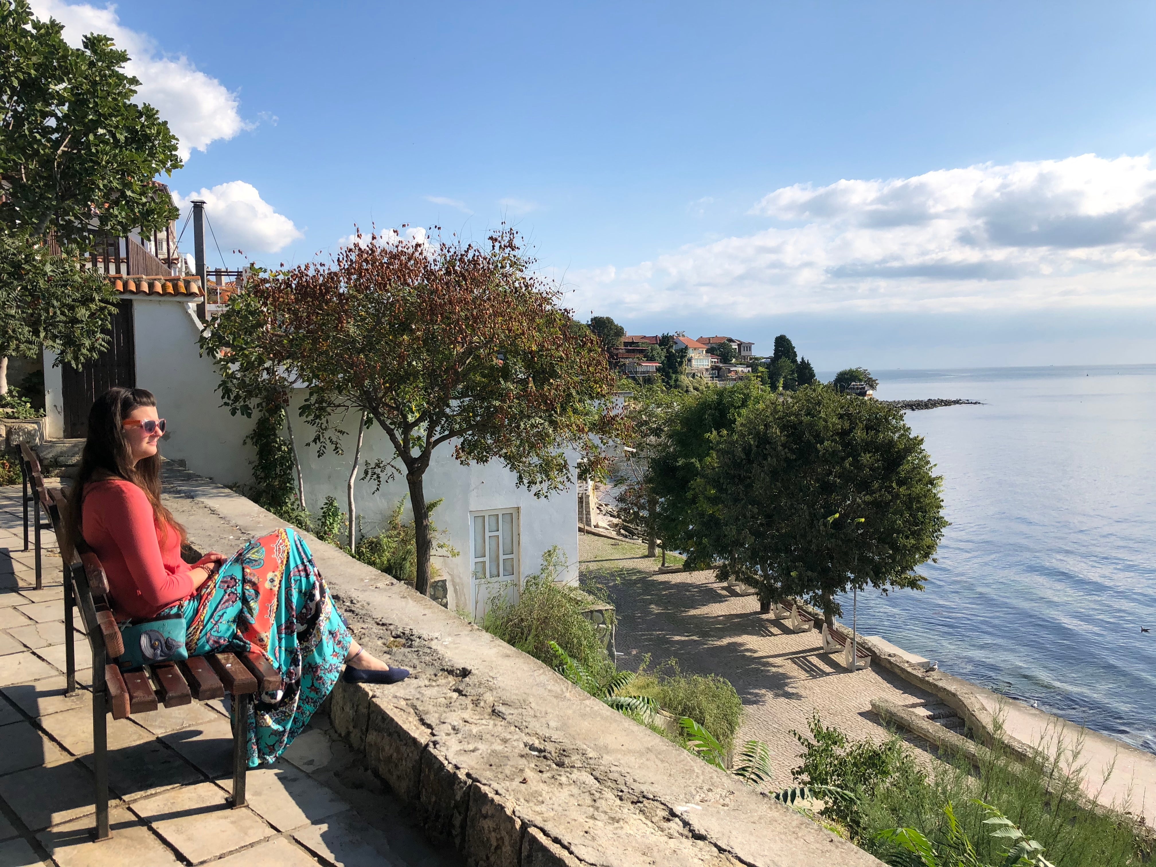 Tess sitting by the Black Sea in Nessebar, Bulgaria