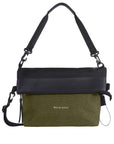  Flat front view of Sherpani's Anti-Theft bag, the Vale AT in Loden with vegan leather accents in black. The top is folded over creating a two-toned reversible overlap. A chair loop lock is clipped onto one side, secured in place by an elastic tab. It has an adjustable/detachable crossbody strap, and a second detachable strap fixed at a shorter length.