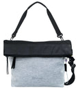  Flat front view of Sherpani's Anti-Theft bag, the Vale AT in Sterling with vegan leather accents in black. The top is folded over creating a two-toned reversible overlap. A chair loop lock is clipped onto one side, secured in place by an elastic tab. It has an adjustable/detachable crossbody strap, and a second detachable strap fixed at a shorter length.