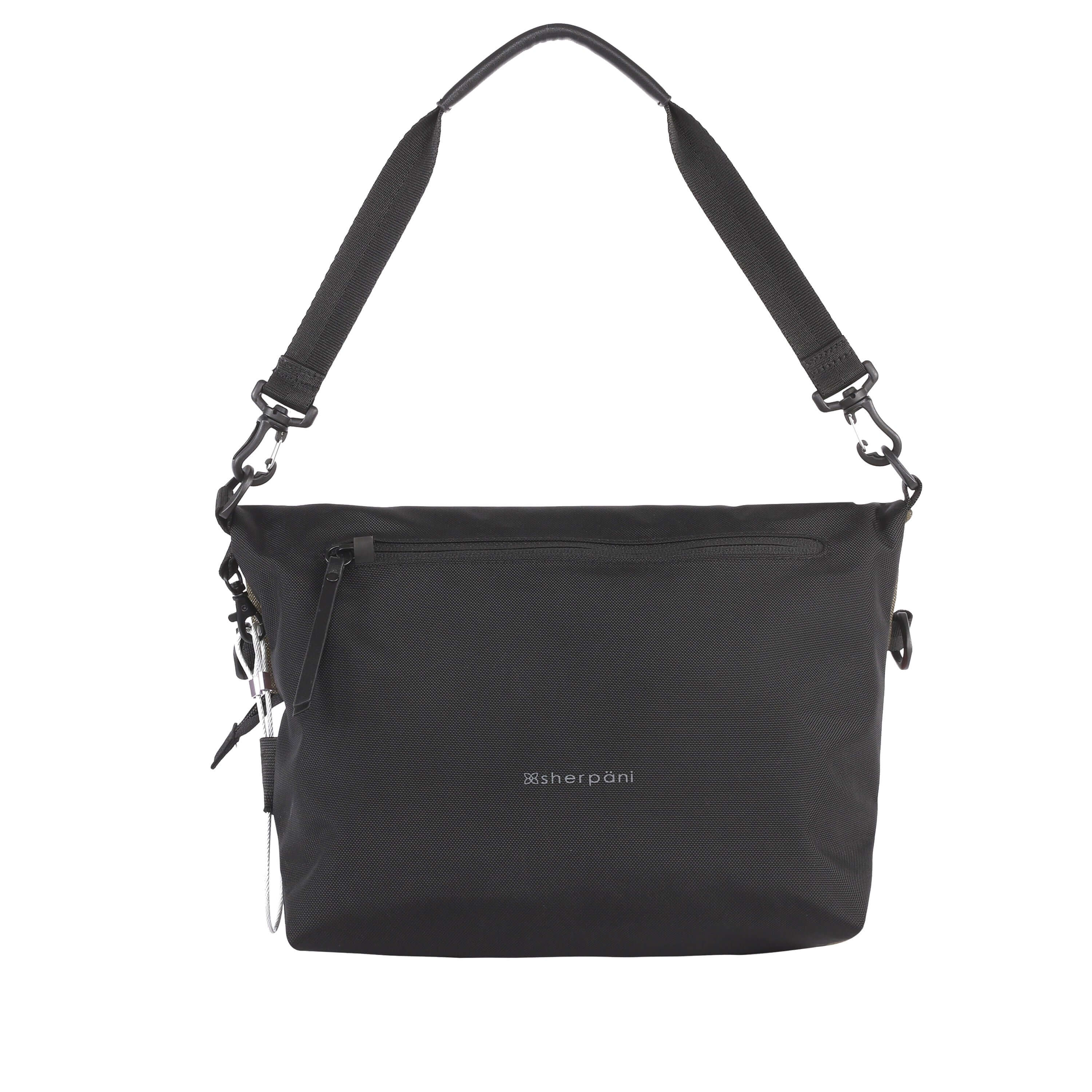 Flat view of the back of Sherpani’s Anti-Theft bag, the Vale AT. The back is entirely black, and has vegan leather accents in black. There is an external pocket with a locking zipper, a chair loop lock on one side, and a detachable short tote handle clipped onto the bag.
