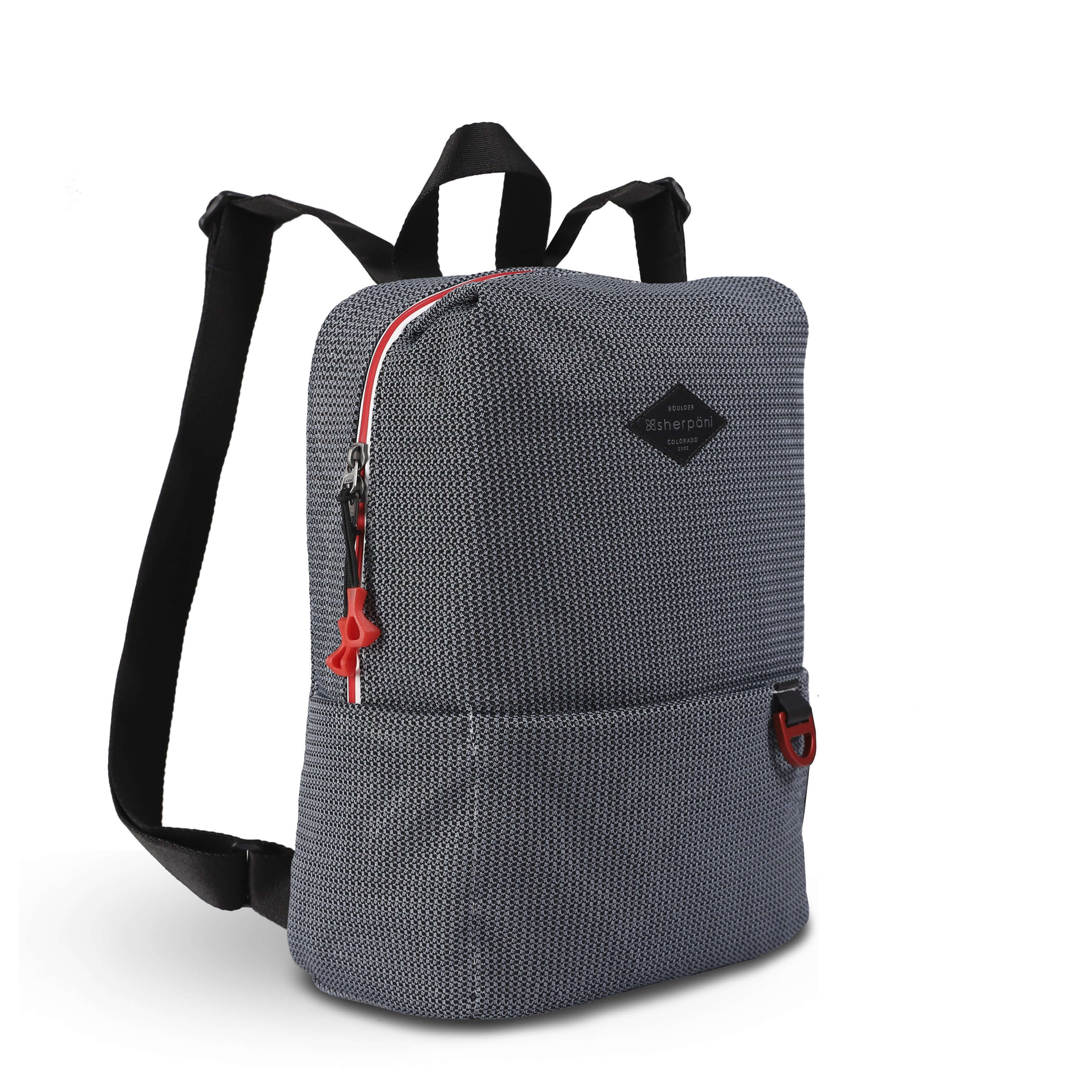 Angled front view of Sherpani mesh backpack, the Adaline. It has a gray and black mesh pattern and features red pops of color on the accent buckle and easy-pull zipper. The bag has black adjustable backpack straps and a tote handle for easy carrying.