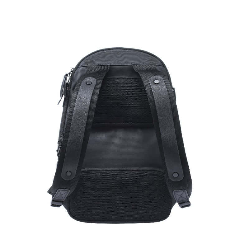 Flat back view of Sherpani's Anti-Theft backpack, the Presta. The back of the back is entirely black, and shows adjustable/padded backpack straps. 