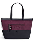 Flat front view of Sherpani's Anti-Theft tote, the Cali AT in Merlot, with vegan leather accents in black. There is an external compartment on the front of the bag with a locking zipper and ReturnMe tag. A chair loop lock is clipped to the side of the bag and is held in place by an elastic tab.