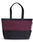 Back view of Sherpani's Anti-Theft tote, the Cali AT in Merlot, with vegan leather accents in black. There is a zipper compartment that acts as a luggage pass-through or trolley sleve, and a chair loop lock on one side that is secured by an elastic tab.