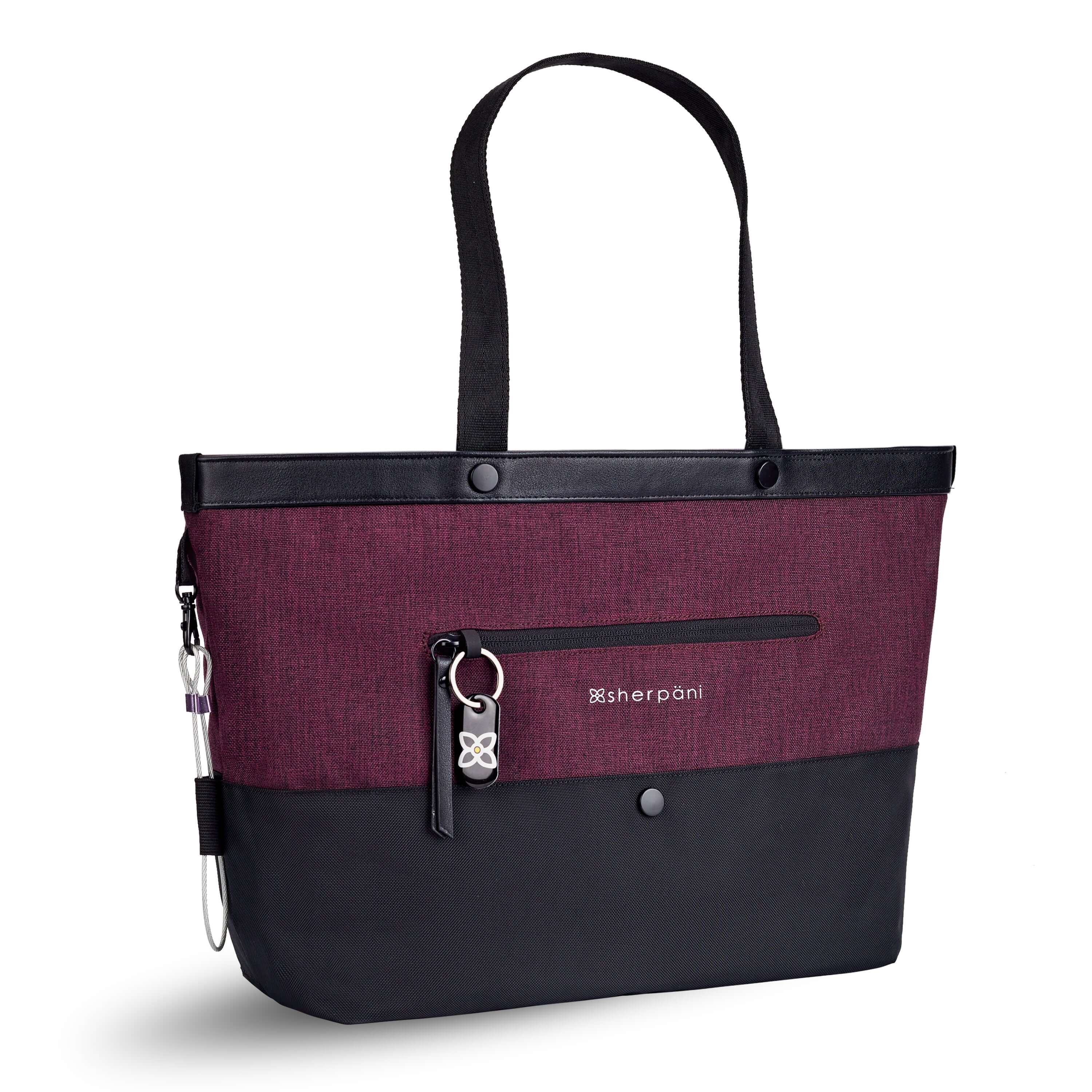 Angled front view of Sherpani's Anti-Theft tote, the Cali AT in Merlot, with vegan leather accents in black. There is an external compartment on the front of the bag with a locking zipper and ReturnMe tag. A chair loop lock is clipped to the side of the bag and is held in place by an elastic tab.