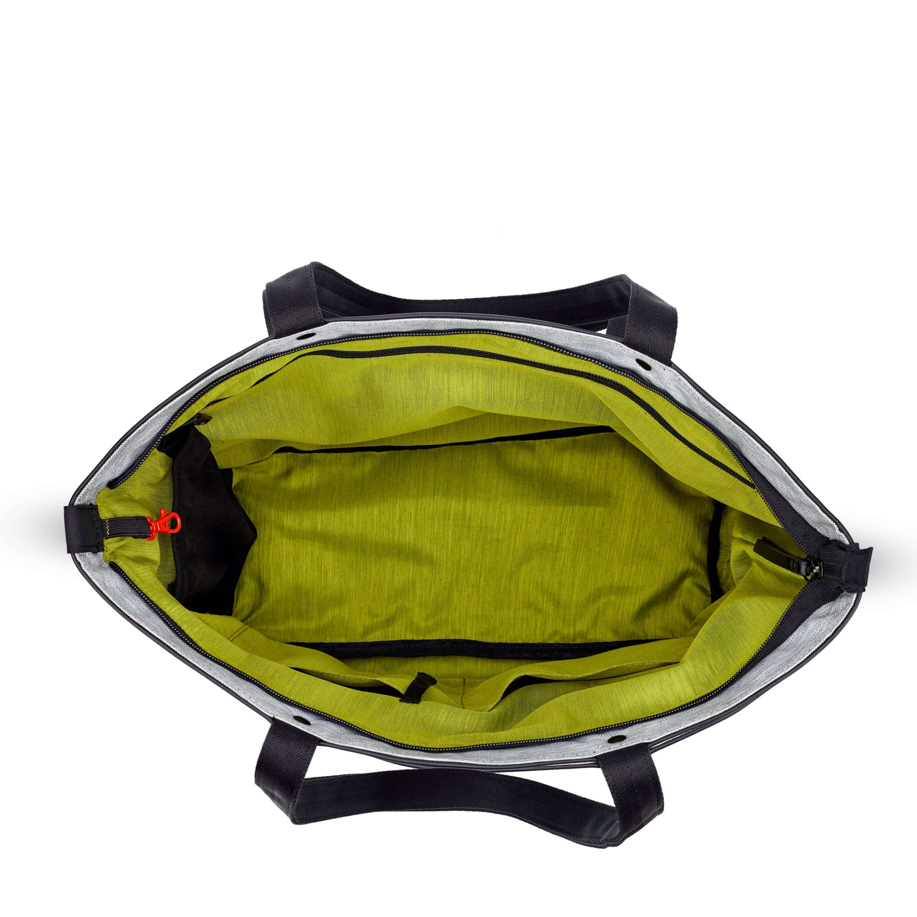 Top view of Sherpani&#39;s Anti-Theft tote the Cali AT in Sterling. The main zipper compartment is open to reveal a lime green interior, an internal water bottle holder and a red carabiner that acts as the zipper lock. 