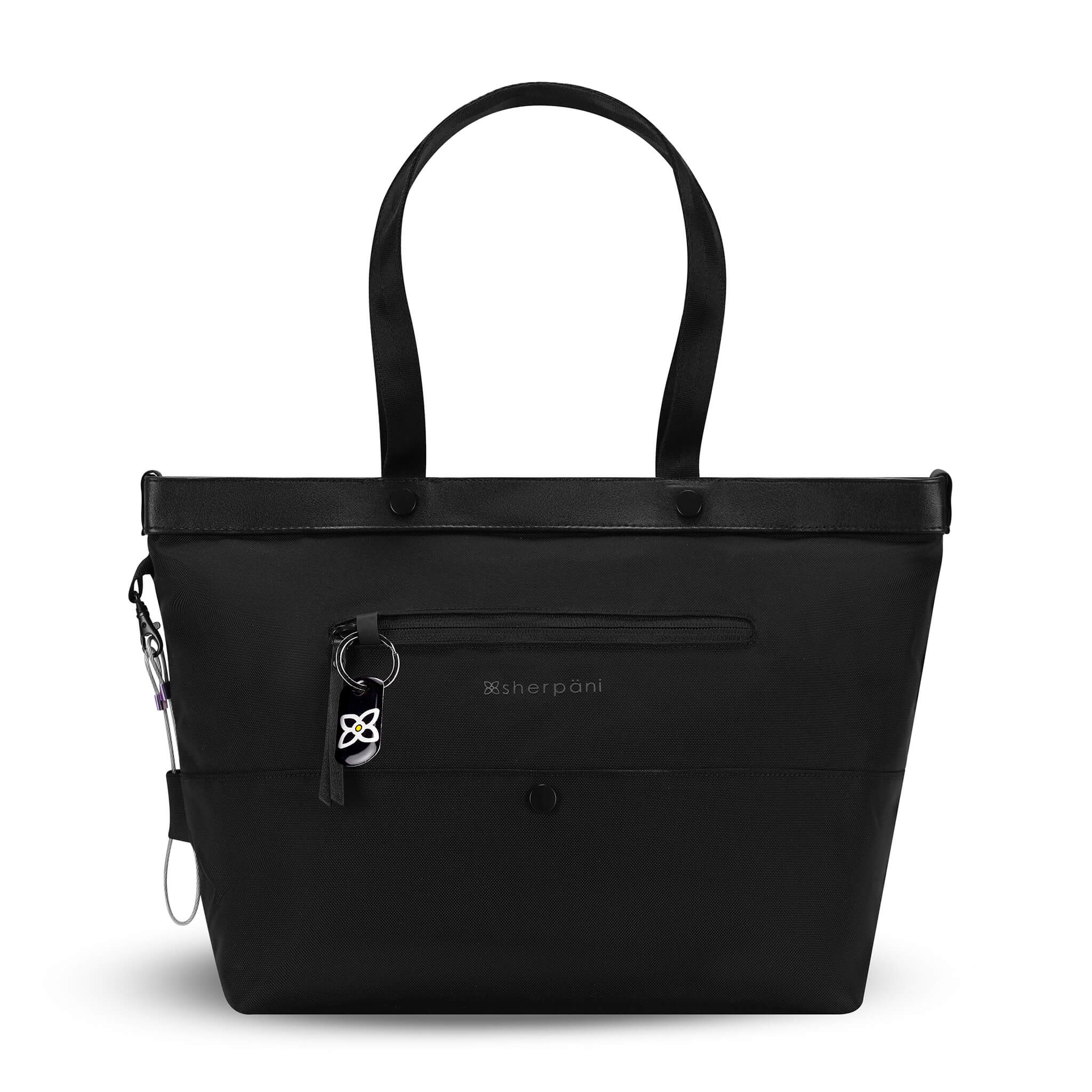 Flat front view of Sherpani's Anti-Theft tote, the Cali AT in Carbon, with vegan leather accents in black. There is an external compartment on the front of the bag with a locking zipper and ReturnMe tag. A chair loop lock is clipped to the side of the bag and is held in place by an elastic tab. 