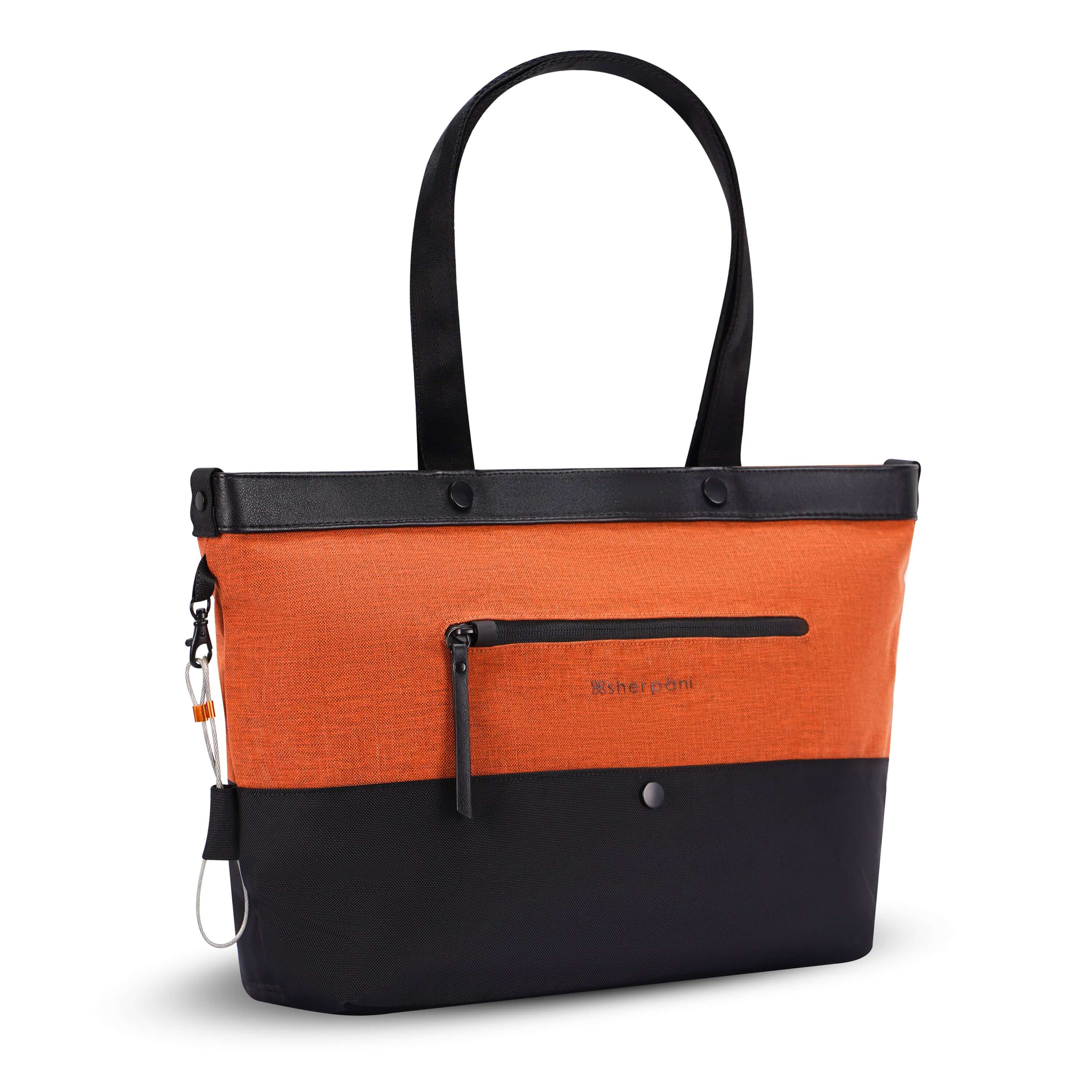 Angled front view of Sherpani's Anti-Theft tote, the Cali AT in Copper, with vegan leather accents in black. There is an external compartment on the front of the bag with a locking zipper. A chair loop lock is clipped to the side of the bag and is held in place by an elastic tab.