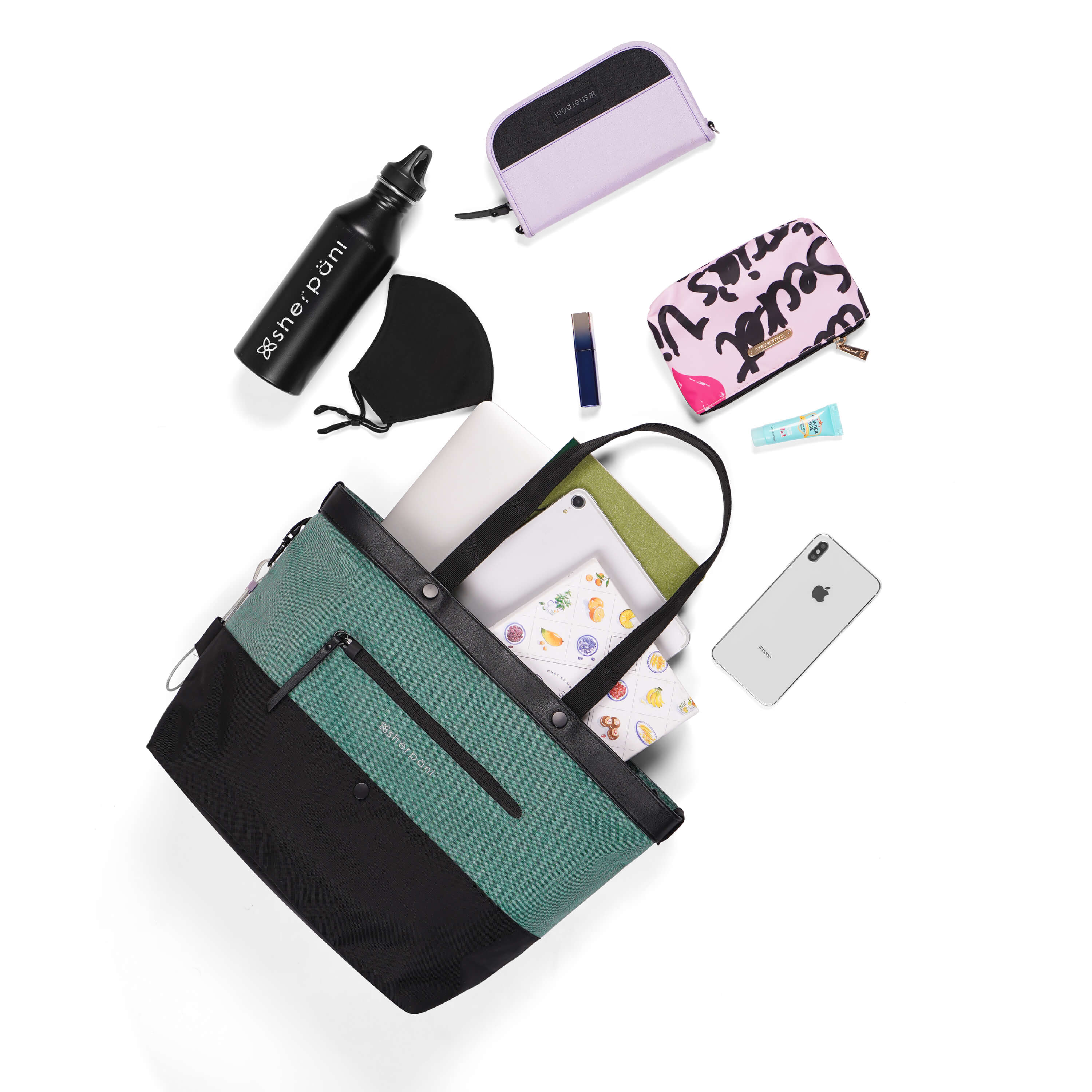 Top view of example items to fill the bag. Sherpani’s Anti-Theft bag, the Cali AT in Teal, lies in the center. It is surrounded by an assortment of items: book, tablet, notepad, laptop, mask, water bottle, Sherpani wallet, lipstick, makeup pouch, hand lotion, and phone. 