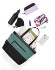 Top view of example items to fill the bag. Sherpani’s Anti-Theft bag, the Cali AT in Teal, lies in the center. It is surrounded by an assortment of items: book, tablet, notepad, laptop, mask, water bottle, Sherpani wallet, lipstick, makeup pouch, hand lotion, and phone.