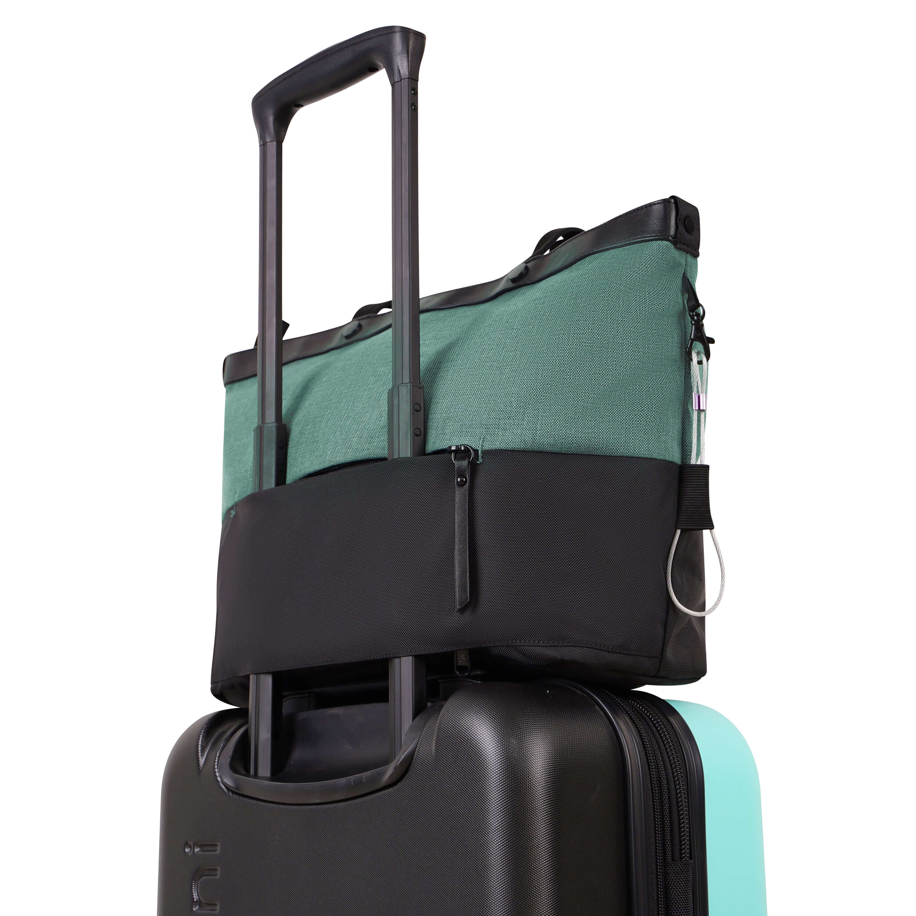 Back view of Sherpani&#39;s Anti-Theft bag the Cali AT in Teal. The exterior zipper pocket is unzipped at both ends creating the luggage pass-through. The bag sits on top of Sherpani&#39;s luggage the Meridian in Caribe, the handle of the suitcase running through the pass-through, securing the Cali AT to the Meridian for easy travel.