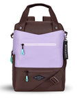 Flat front view of Sherpani's three-in-one bag, the Camden in Lavender. The bag is two-toned in lavender and brown. There are two external zipper pockets on the front panel with easy-pull zippers in aqua. A branded Sherpani keychain is clipped to the upper right corner. An elastic water bottle holder sits on either side of the bag. The bag has an adjustable/detachable crossbody strap, padded/adjustable backpack straps and short tote handles fixed at the top.