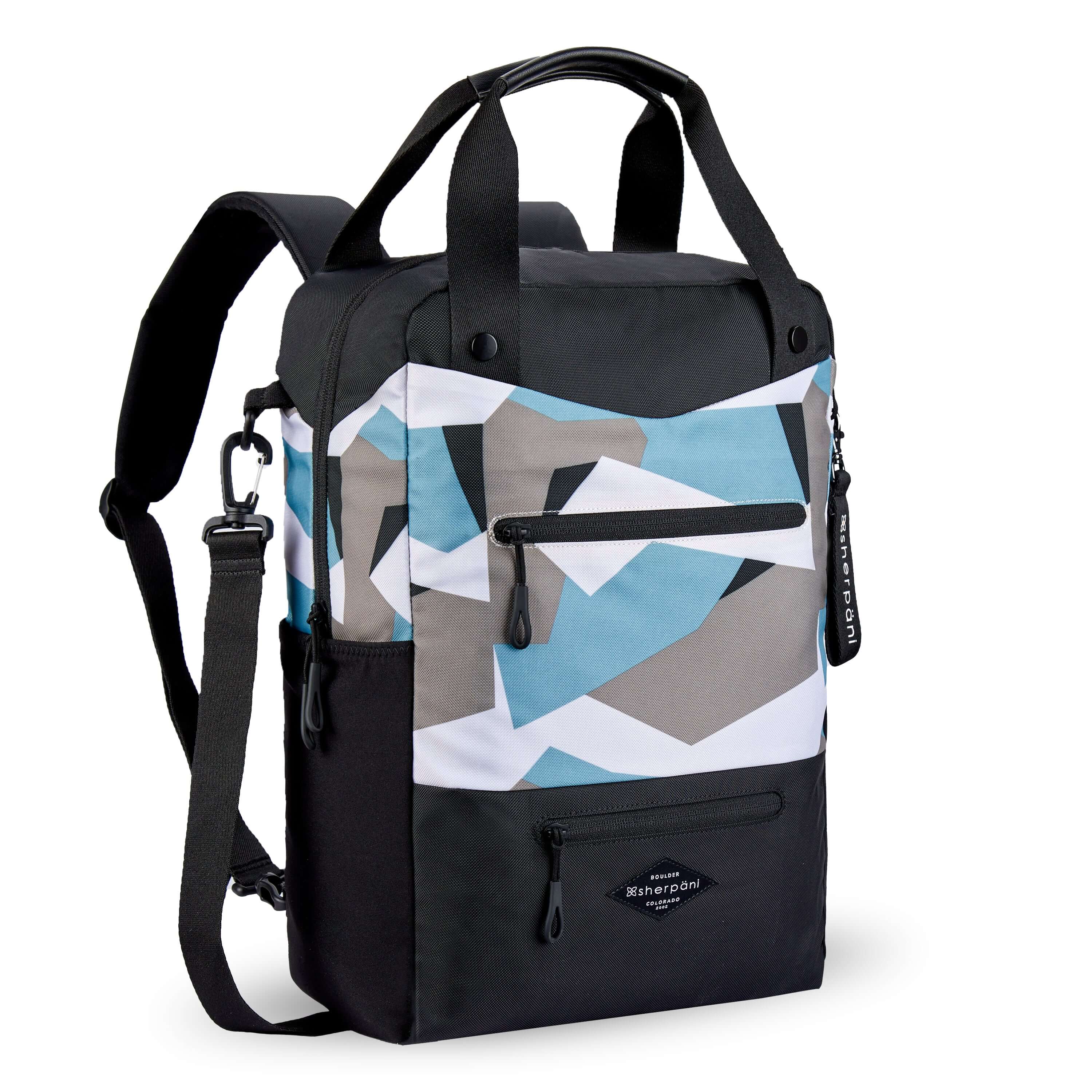 Angled front view of Sherpani's three-in-one bag, the Camden in Summer Camo. The bag is two-toned in black and in a camouflage pattern of blue, grey and white. There are two external zipper pockets on the front panel with easy-pull zippers in black. A branded Sherpani keychain is clipped to the upper right corner. An elastic water bottle holder sits on either side of the bag. The bag has an adjustable/detachable crossbody strap, padded/adjustable backpack straps and short tote handles fixed at the top.