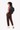 A model carries Sherpani three-in-one bag, the Camden in Raven, as a backpack. #color_raven
