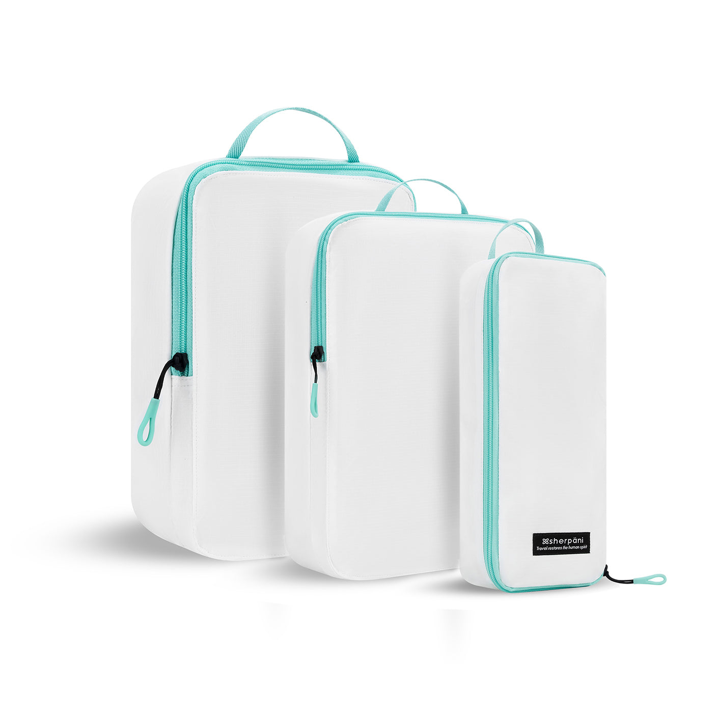 Angled front view of the Compass Packing Cubes in three sizes: small, medium and large. The cubes are white with zipper and handle accented in aqua. 
