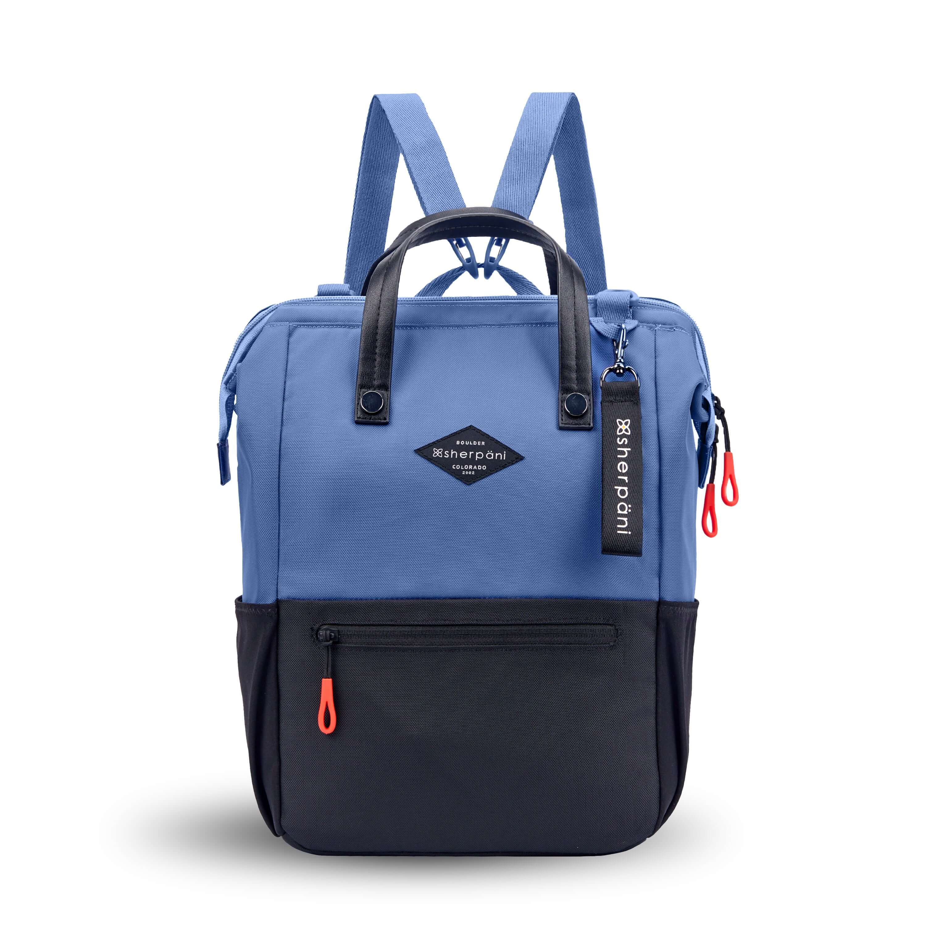Flat front view of Sherpani three-in-one bag, the Dispatch in Pacific Blue. The bag is two-toned: the top is ocean blue and the bottom is black. There is an external zipper pocket on the front panel. Easy-pull zippers are accented in red. A branded Sherpani keychain is clipped to the upper right corner. Elastic water bottle holders sit on either side of the bag. It has short tote handles and adjustable/detachable straps that can function for a backpack or crossbody.