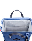Top view of Sherpani three-in-one bag, the Dispatch in Pacific Blue. The main zipper compartment is open to reveal a doctor bag style opening with a rectangular metal frame. The inside of the bag is light gray and features an internal pouch.