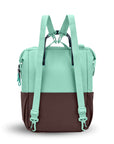 Back view of Sherpani three-in-one bag, the Dispatch in Seagreen. The detachable straps are shown in the backpack style.