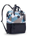Angled front view of Sherpani three-in-one bag, the Dispatch in Summer Camo. The bag is two-toned: the top is a camouflage pattern of light blue, gray and white, the bottom is black. There is an external zipper pocket on the front panel. Easy-pull zippers are accented in black. A branded Sherpani keychain is clipped to the upper right corner. Elastic water bottle holders sit on either side of the bag. It has short tote handles and adjustable/detachable straps that can function for a backpack or crossbody.
