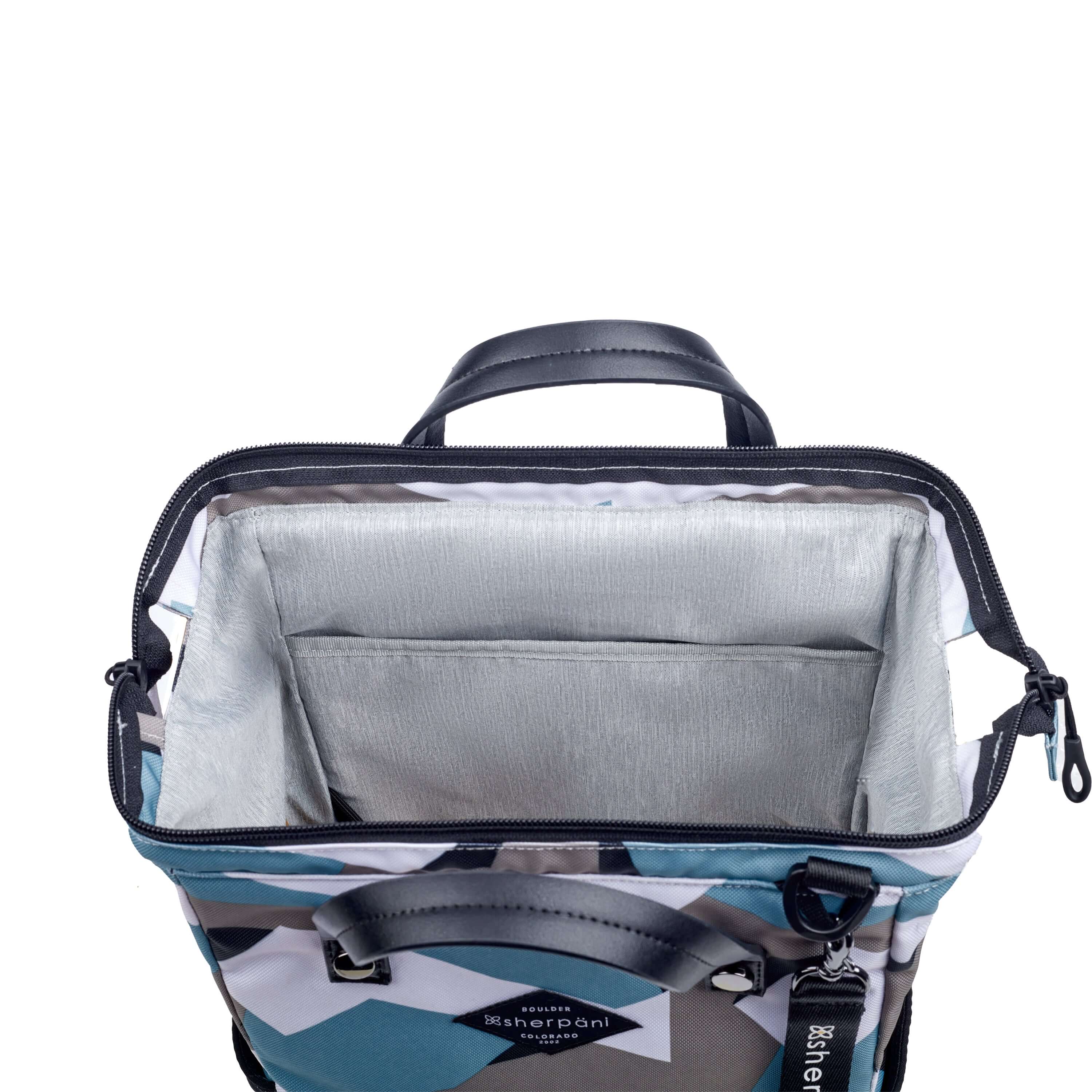 Top view of Sherpani three-in-one bag, the Dispatch in Summer Camo. The main zipper compartment is open to reveal a doctor bag style opening with a rectangular metal frame. The inside of the bag is light gray and features an internal pouch. 
