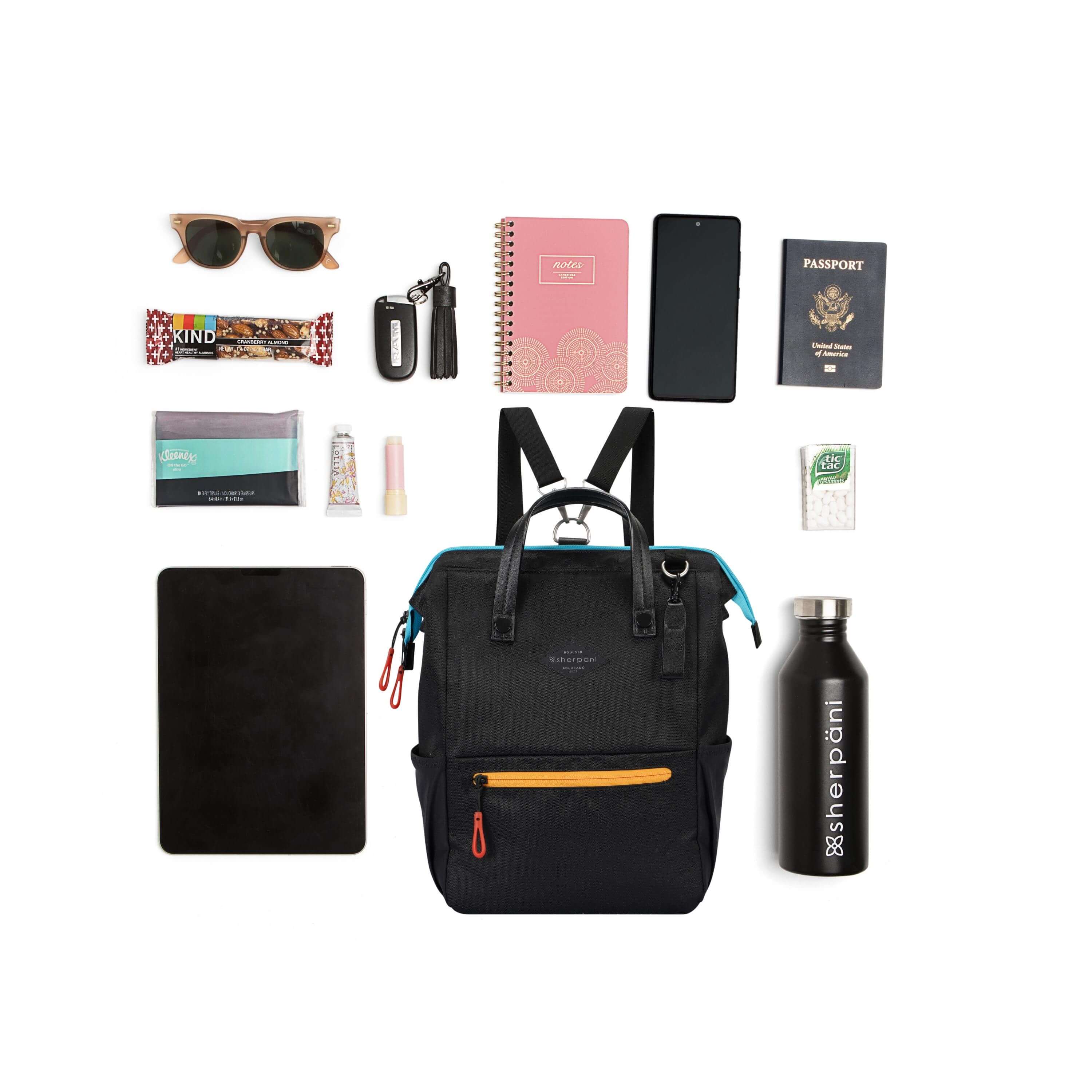 Top view of example items to fill the bag. Sherpani three-in-one bag, the Dispatch in Chromatic, lies in the center. It is surrounded by an assortment of items: sunglasses, granola bar, tissues, tablet, hand lotion, lip balm, car key, notebook, phone, passport, mints and water bottle. 