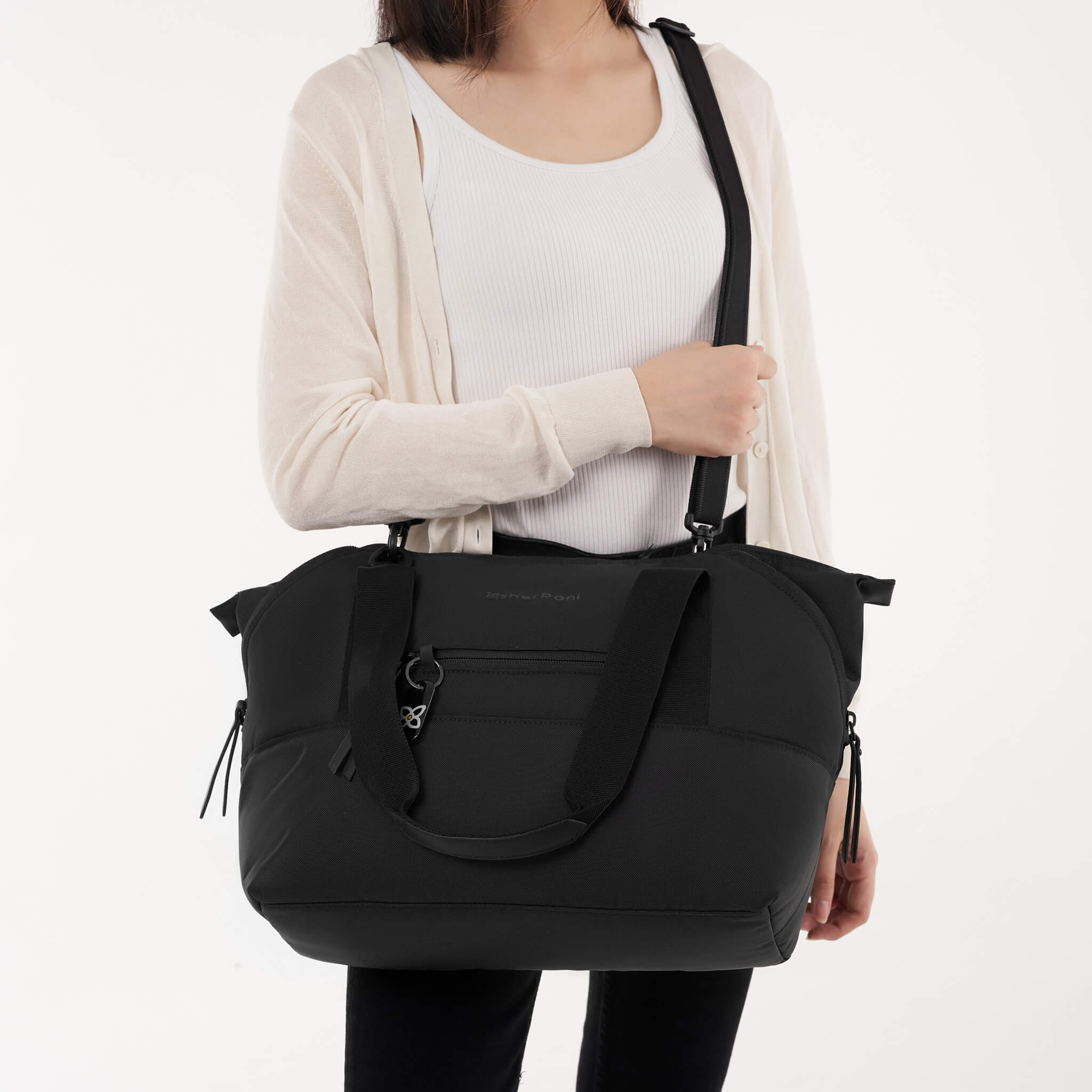 A model using the detachable strap to style the Eclipse in Carbon as a crossbody handbag. 