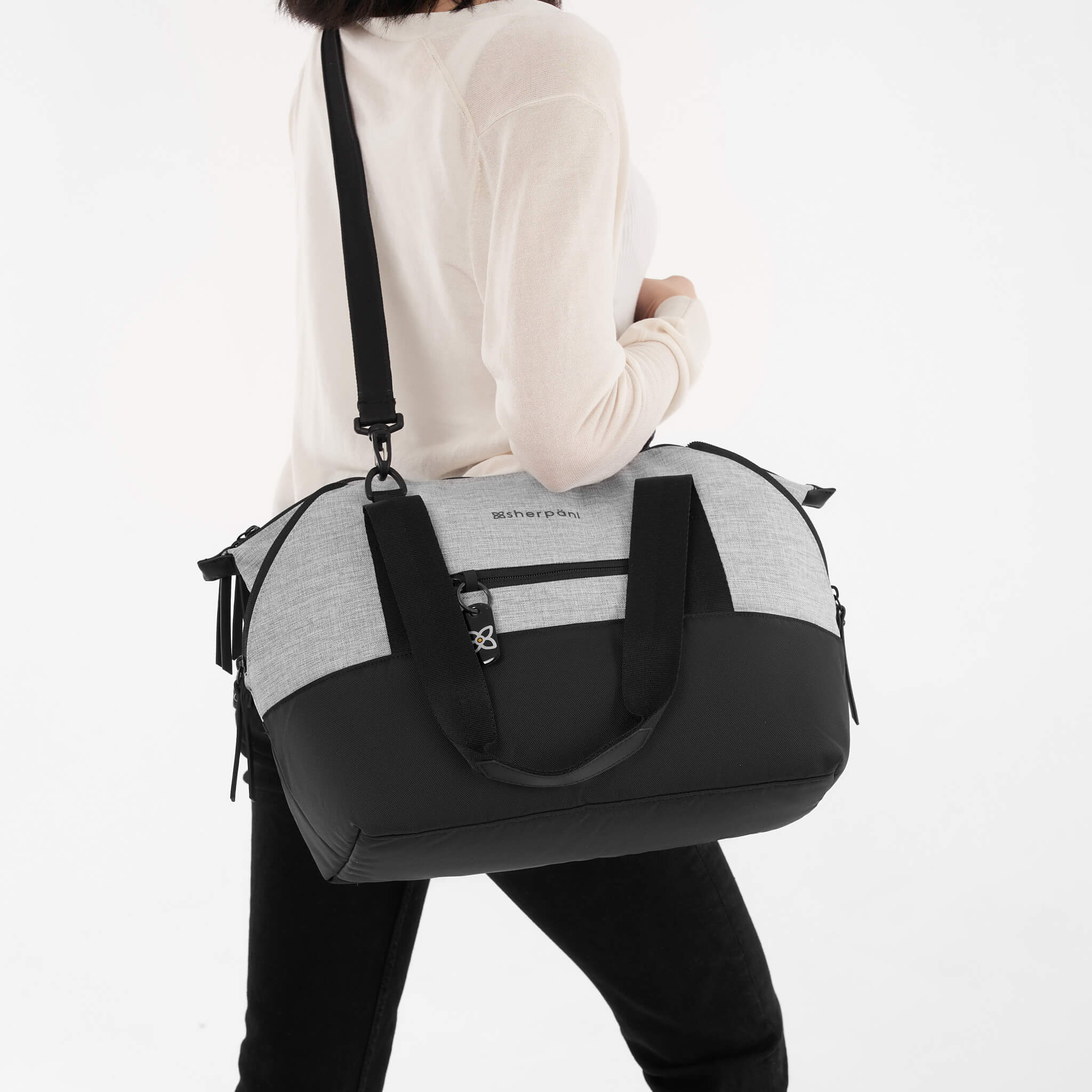 A model using the removable strap to wear the Eclipse in Sterling as a large crossbody purse. 