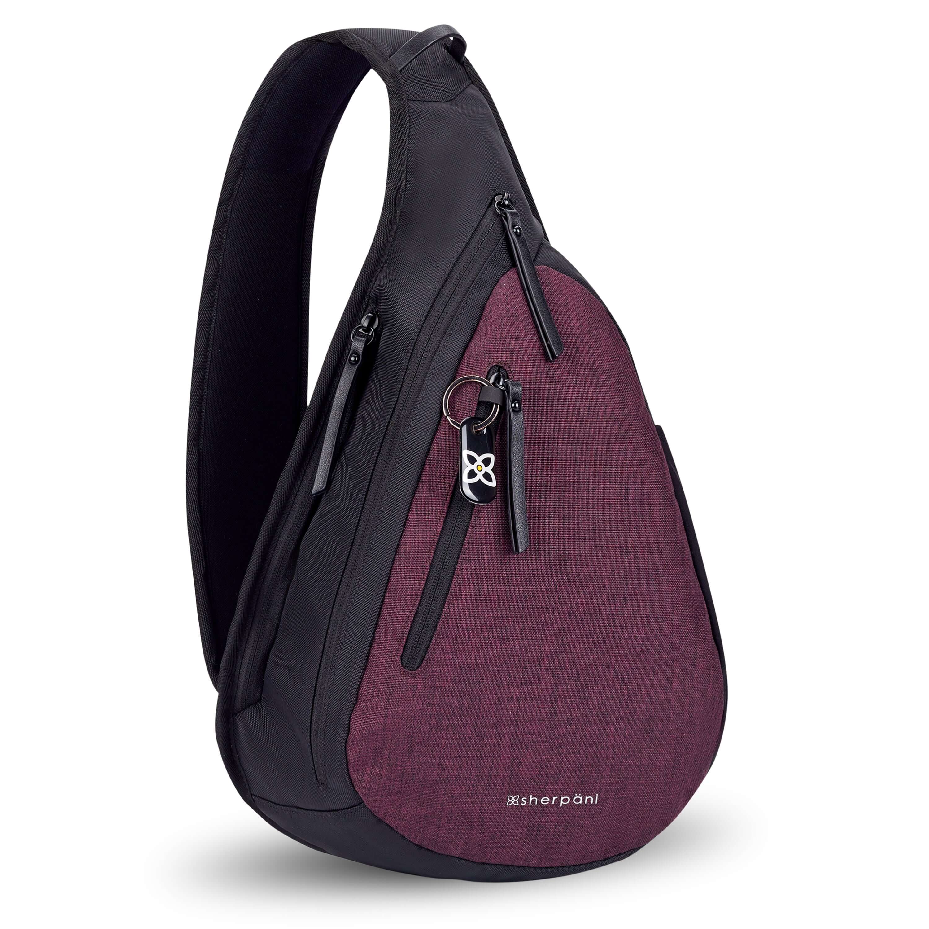  Angled front view of Sherpani&#39;s Anti-Theft bag, the Esprit AT in Merlot, with vegan leather accents in black. There is a locking zipper compartment on the front, and two more zipper compartments on the side. An elastic water bottle holder sits on the other side of the bag.